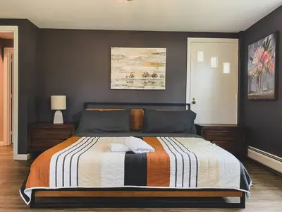 a bedroom with a bed with a striped blanket at Centrally Located - 3 Br House in Southington