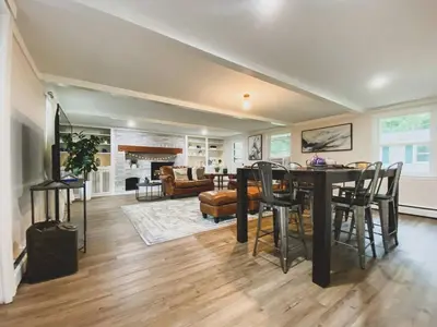 a dining room and living room with a table and chairs at Centrally Located - 3 Br House in Southington