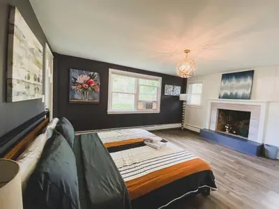 a living room with a bed and a fireplace at Centrally Located - 3 Br House in Southington