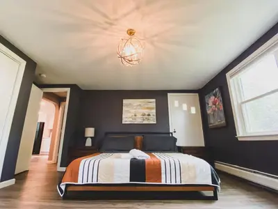 a bedroom with a bed and a chandelier at Centrally Located - 3 Br House in Southington