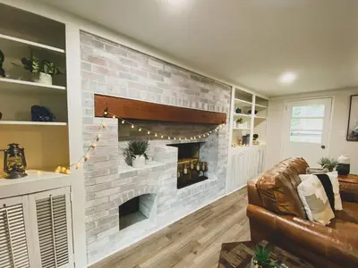 a living room with a brick fireplace at Centrally Located - 3 Br House in Southington