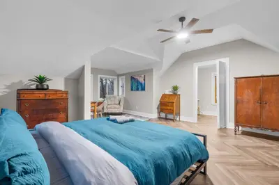 a bedroom with a blue bed and a ceiling fan at Spacious Cozy 3 Bed 2 Bath in Southington