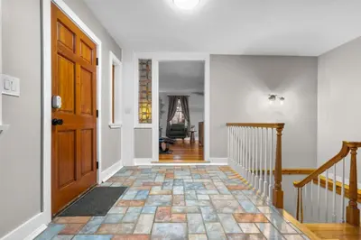 a hallway with a wooden door and a staircase at Spacious Cozy 3 Bed 2 Bath in Southington