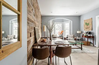 a dining room with a wooden table and chairs at Main Street cabin in Millerton