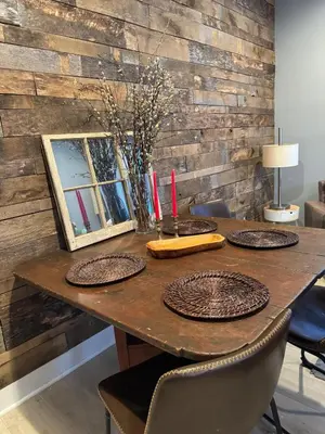 a wooden table with plates and candles on it at Main Street cabin in Millerton