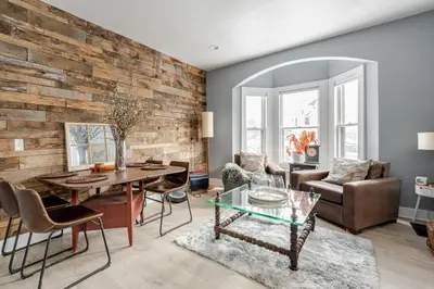 a living room with a wooden wall at Main Street cabin in Millerton