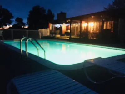 a swimming pool at night with lights in it at Charming home - views of Hunter Mountain slopes in Hunter