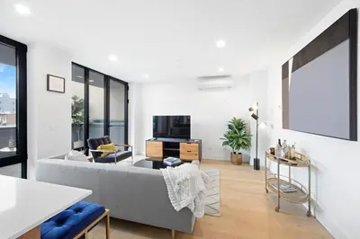 a living room with a couch and a tv at 149BK-501 New 2br 2baths with a Private Terrace in Brooklyn