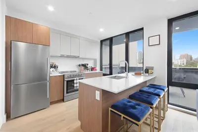 a kitchen with stainless steel appliances and blue stools at 149BK-501 New 2br 2baths with a Private Terrace in Brooklyn
