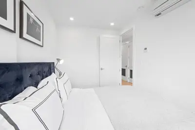 a white bedroom with a large white bed with pillows at 149BK-501 New 2br 2baths with a Private Terrace in Brooklyn