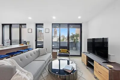 a living room with a couch and a flat screen tv at 149BK-501 New 2br 2baths with a Private Terrace in Brooklyn