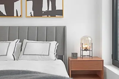 a bedroom with a bed with a gray headboard at 149BK-501 New 2br 2baths with a Private Terrace in Brooklyn