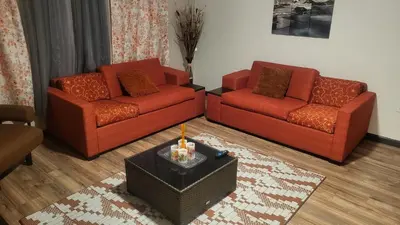 a living room with two red couches and a table at Hidden Gem in Middletown