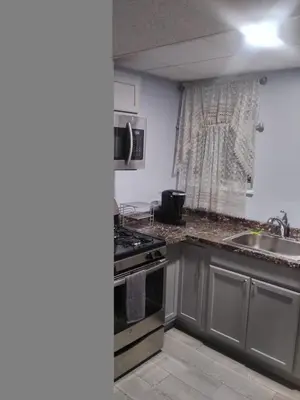 a kitchen with a sink and a stove top oven at Hidden Gem in Middletown