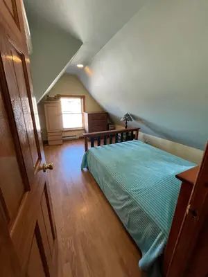 a bedroom with a bed and a window at Grand 2BR near MetroNorth with easy parking in Yonkers