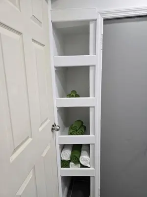 a closet with a door open with towels at The Georges Hidden Gem in Mount Vernon