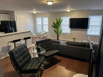 a living room with a couch and a table at Luxury Townhouse in Newark in Newark