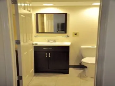 a bathroom with a sink and a toilet and a mirror at Countryside Motel in Fishkill