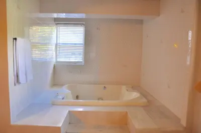 a white bath tub in a bathroom with a window at Countryside Motel in Fishkill