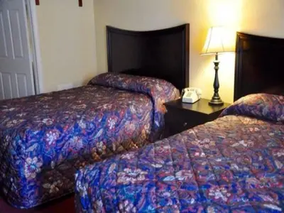 a hotel room with two beds and a phone on a table at Countryside Motel in Fishkill