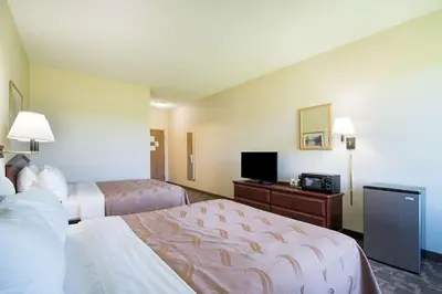 a hotel room with two beds and a flat screen tv at Quality Inn & Suites Schoharie near Howe Caverns in Schoharie