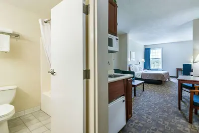 a hotel room with a bathroom and a bedroom at Quality Inn & Suites Schoharie near Howe Caverns in Schoharie