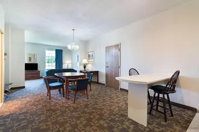 a living room with a table and chairs at Quality Inn & Suites Schoharie near Howe Caverns in Schoharie