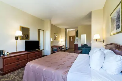 a hotel room with a bed and a flat screen tv at Quality Inn & Suites Schoharie near Howe Caverns in Schoharie