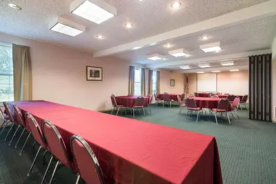a conference room with a red table and chairs at Quality Inn & Suites Schoharie near Howe Caverns in Schoharie