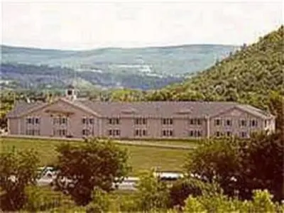 a large building in the middle of a field at Quality Inn & Suites Schoharie near Howe Caverns in Schoharie