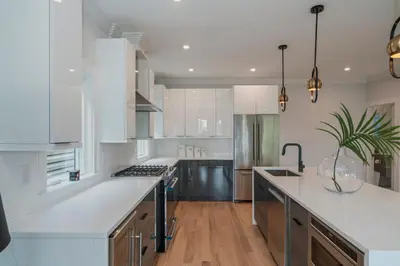 a kitchen with white cabinets and a large white counter top at Modern Luxury 3BR 2BA 10 minutes to NYC in Weehawken