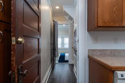 a hallway with a door leading to a bedroom at Fully-stocked Kitchen, AC, WiFi, WD, Near Baseball and Downtown in Oneonta