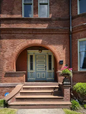an entrance to a brick building with a blue door at The Grand - The Nicest House in Newburgh in Newburgh
