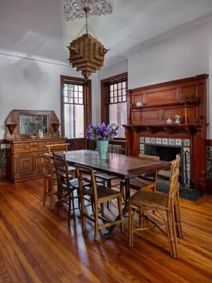 a dining room with a table and chairs and a fireplace at The Grand - The Nicest House in Newburgh in Newburgh