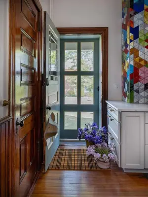 a kitchen with an open door with flowers on the floor at The Grand - The Nicest House in Newburgh in Newburgh