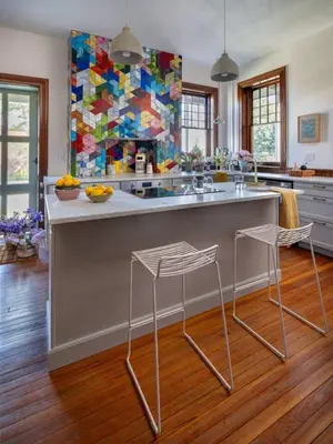 a kitchen with a large island with two stools at The Grand - The Nicest House in Newburgh in Newburgh
