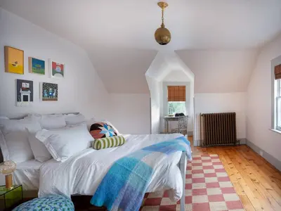 a bedroom with a white bed and a rug at The Grand - The Nicest House in Newburgh in Newburgh