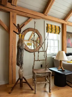 a living room with a chair and a mirror at Post & Beam - Stunningly Designed Luxury Home with Pool & Hot Tub in Pine Plains