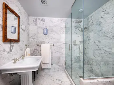 a bathroom with a sink and a glass shower at Post & Beam - Stunningly Designed Luxury Home with Pool & Hot Tub in Pine Plains