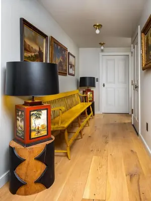 a living room with a bench and a lamp at Post & Beam - Stunningly Designed Luxury Home with Pool & Hot Tub in Pine Plains