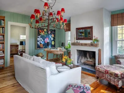 a living room with a white couch and a fireplace at Willow Vale - Stunningly Designed Historical Icon with Hot Tub in Pine Plains