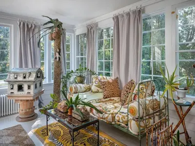 a living room with a couch and some windows at Willow Vale - Stunningly Designed Historical Icon with Hot Tub in Pine Plains