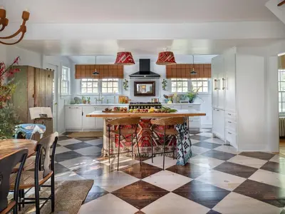 a kitchen with a checkered floor and a large island at Willow Vale - Stunningly Designed Historical Icon with Hot Tub in Pine Plains
