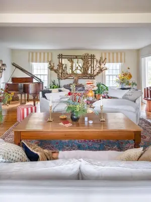 a living room with a coffee table and a piano at Willow Vale - Stunningly Designed Historical Icon with Hot Tub in Pine Plains