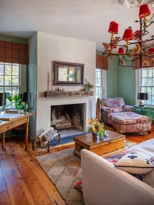 a living room with a couch and a fireplace at Willow Vale - Stunningly Designed Historical Icon with Hot Tub in Pine Plains
