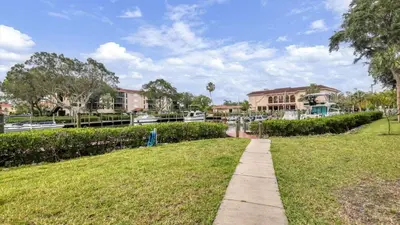 a walkway through a park with houses in the background at MA25188C-103 in New York