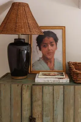 a lamp on a table with a picture and a book at The Bend in Phoenicia