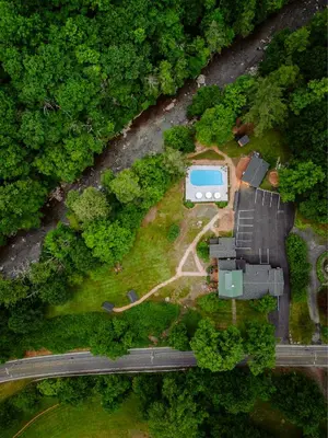 an aerial view of a house in the middle of a forest at The Bend in Phoenicia