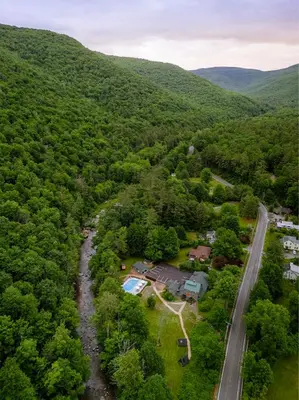 an aerial view of a house in the middle of a forest at The Bend in Phoenicia