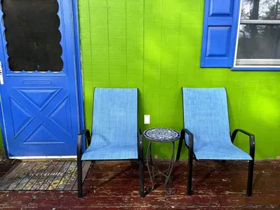two chairs and a table in front of a door at Roscoe Pine House in Roscoe